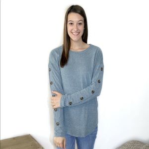 Brand new long sleeve blue top with buttons down the sleeve. Super soft